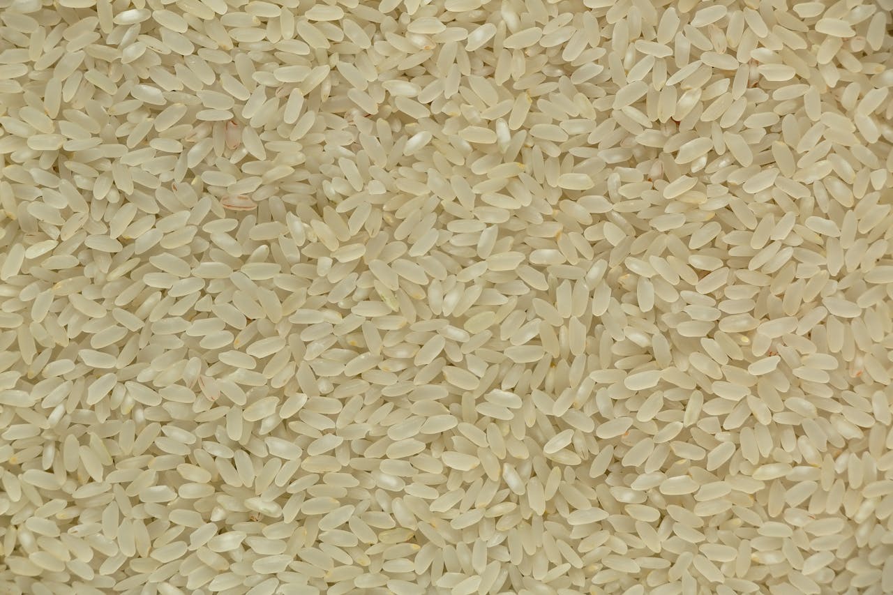 Detailed close-up of raw white rice grains, showing their texture and natural color.